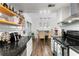 Open kitchen with granite countertops, white cabinets, and view into dining area at 6900 Roswell Rd # 3N, Atlanta, GA 30328