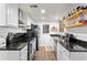 Efficient kitchen with granite counters, white cabinets, and modern appliances at 6900 Roswell Rd # 3N, Atlanta, GA 30328