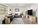 Inviting living room featuring a plush grey sofa, neutral rug, and lots of natural light at 6900 Roswell Rd # 3N, Atlanta, GA 30328