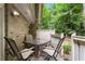 Cozy patio featuring outdoor dining set and lovely view of mature trees beyond the fence at 6900 Roswell Rd # 3N, Atlanta, GA 30328