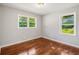 Bedroom with hardwood floors, gray walls, and two windows offering natural light at 765 Shellnut Dr, Forest Park, GA 30297