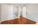 Bedroom featuring hardwood floors, a closet, and a doorway leading to the hallway at 765 Shellnut Dr, Forest Park, GA 30297
