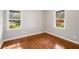 Cozy bedroom with hardwood floors, neutral walls, and natural light from two windows at 765 Shellnut Dr, Forest Park, GA 30297