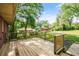 Wooden deck overlooks the spacious, green backyard with mature trees and outbuildings at 765 Shellnut Dr, Forest Park, GA 30297