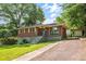 Charming brick home with a well-maintained lawn and a covered carport at 765 Shellnut Dr, Forest Park, GA 30297