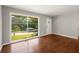 Sun-filled living room with hardwood floors and a large window overlooking the yard at 765 Shellnut Dr, Forest Park, GA 30297