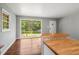 Bright living room with wood floors, a large window, and an island bar, perfect for relaxing or entertaining at 765 Shellnut Dr, Forest Park, GA 30297