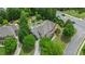 Aerial view of a home with a backyard pool, manicured lawn, patio area and mature trees at 100 Braxton Way, Roswell, GA 30075