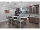 Stylish wet bar featuring a wood facade, bar seating, cabinets, and a television at 100 Braxton Way, Roswell, GA 30075
