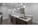 Open wet bar features a long marbled countertop, built in cabinets, and stainless steel dishwasher at 100 Braxton Way, Roswell, GA 30075