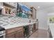 Modern bar area with mosaic backsplash, wine fridge, and floating shelves for storage at 100 Braxton Way, Roswell, GA 30075