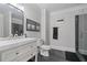 Modern bathroom featuring gray slate flooring, a glass shower, and a stylish white vanity with brushed nickel hardware at 100 Braxton Way, Roswell, GA 30075