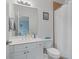 Functional bathroom with a white single sink vanity, shower with curtain and tile, plus toilet at 100 Braxton Way, Roswell, GA 30075