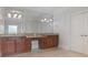 Bathroom with dual sinks, granite countertops, and wood cabinets at 100 Braxton Way, Roswell, GA 30075