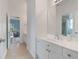 Well-maintained bathroom with a white vanity and neutral floor leads into the bedroom at 100 Braxton Way, Roswell, GA 30075