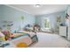 Bright bedroom with blue walls, plush carpet, charming wall decorations, and a window seat overlooking the yard at 100 Braxton Way, Roswell, GA 30075