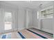 Bright bonus room with natural light, featuring an exterior door, and neutral decor with a colorful striped rug at 100 Braxton Way, Roswell, GA 30075