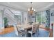 Bright dining room featuring hardwood floors, white trim, blue walls, chandelier and staircase nearby at 100 Braxton Way, Roswell, GA 30075
