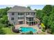 Stunning exterior elevation with a pool, spa, patio, and tiered deck perfect for outdoor living and entertaining at 100 Braxton Way, Roswell, GA 30075