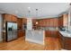 Beautiful kitchen with stainless steel appliances, hardwood flooring, and a breakfast bar at 100 Braxton Way, Roswell, GA 30075