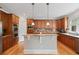 Open kitchen featuring stainless steel appliances, hardwood flooring, and ample cabinet space at 100 Braxton Way, Roswell, GA 30075