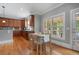 Bright eat-in kitchen features wooden cabinets, stainless steel appliances, and hardwood flooring at 100 Braxton Way, Roswell, GA 30075