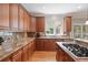 Kitchen with tile backsplash, long stone countertops, and stainless steel appliances at 100 Braxton Way, Roswell, GA 30075