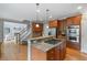 Open-concept kitchen flows into the living area with a gas range cooktop at 100 Braxton Way, Roswell, GA 30075