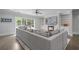 Bright Gathering living room with a fireplace, built in shelving, television and oversized gray sofa at 100 Braxton Way, Roswell, GA 30075