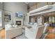 Spacious living room featuring a fireplace, built-in bookshelves, hardwood floors and a soaring ceiling at 100 Braxton Way, Roswell, GA 30075