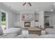 Gathering living room with a fireplace, built in shelving, television and oversized gray sofa at 100 Braxton Way, Roswell, GA 30075