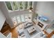 Bright living room featuring a fireplace, large windows, and views of the pool and trees at 100 Braxton Way, Roswell, GA 30075