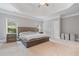 Spacious bedroom with a tray ceiling, complemented by large windows for natural light at 100 Braxton Way, Roswell, GA 30075