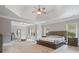 Spacious bedroom with a tray ceiling, complemented by large windows for natural light at 100 Braxton Way, Roswell, GA 30075