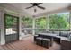 Relaxing screened porch with outdoor seating and ceiling fan, offering a tranquil view of the backyard at 100 Braxton Way, Roswell, GA 30075
