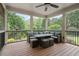 Inviting screened-in porch with comfortable seating, perfect for enjoying the outdoors in any weather at 100 Braxton Way, Roswell, GA 30075