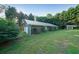 Backyard with long lawn leading to a garage and an adjacent storage shed at 1003 Wiley Bridge Rd, Woodstock, GA 30188