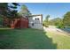 Exterior view with a side yard and an access road at 1003 Wiley Bridge Rd, Woodstock, GA 30188