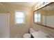 Bathroom featuring a large, framed mirror and tile backsplash over the vanity at 1003 Wiley Bridge Rd, Woodstock, GA 30188