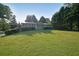 Charming single-story home with a well-manicured lawn, mature trees, and metal roof at 1003 Wiley Bridge Rd, Woodstock, GA 30188