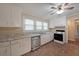Functional kitchen with white cabinetry, faux marble countertops, and stainless steel dishwasher at 1003 Wiley Bridge Rd, Woodstock, GA 30188