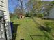 Expansive backyard featuring a storage shed, enclosed by a chain-link fence, offering space and utility at 1243 Hill Nw St, Conyers, GA 30012