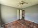 Empty bedroom featuring damaged hardwood floors, neutral walls, and basic ceiling fan at 1243 Hill Nw St, Conyers, GA 30012