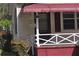 Close-up of the front porch with a red awning and decorative railing and house number at 1243 Hill Nw St, Conyers, GA 30012