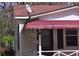 Detailed view of the home's entrance featuring a red awning and porch sign at 1243 Hill Nw St, Conyers, GA 30012