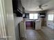 A kitchen with tile floors, a window, and appliances, ready for renovation at 1243 Hill Nw St, Conyers, GA 30012