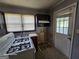 Close-up of kitchen, featuring a window and appliances, needing TLC at 1243 Hill Nw St, Conyers, GA 30012