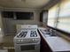 Close-up of kitchen, featuring a window and appliances, needing TLC at 1243 Hill Nw St, Conyers, GA 30012