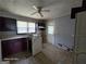 A kitchen with tile floors, a window, and appliances, ready for renovation at 1243 Hill Nw St, Conyers, GA 30012