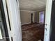 View of the interior of a home with peeling wood floors, white trim, and beige colored walls at 1243 Hill Nw St, Conyers, GA 30012